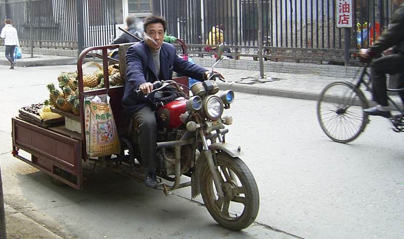 man on a flat-bed motorbike