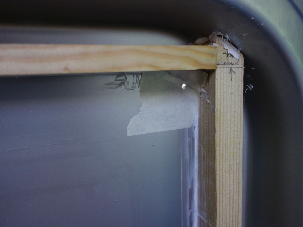 window frame as far up and forward as possible