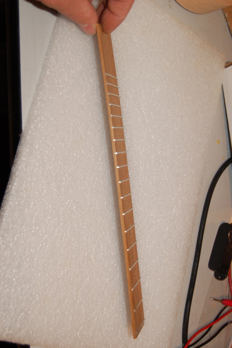 side view showing curve in fretboard