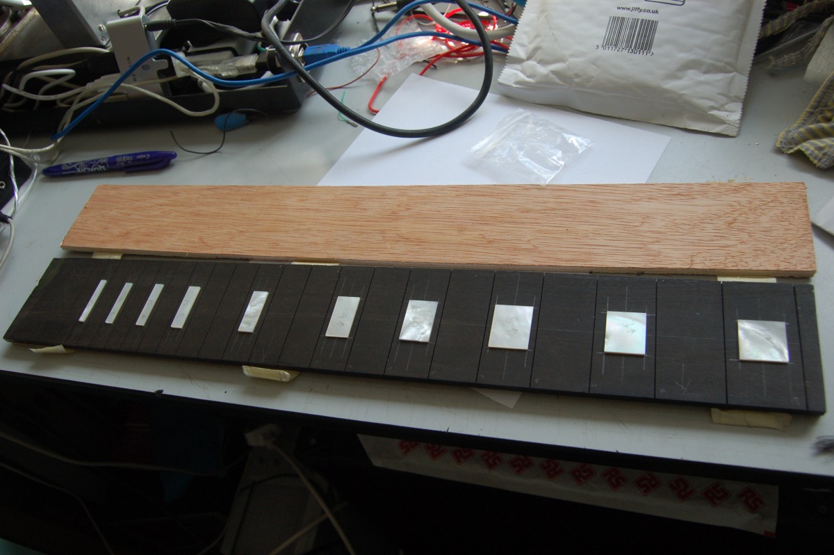 inlays laid out on fretboard blank