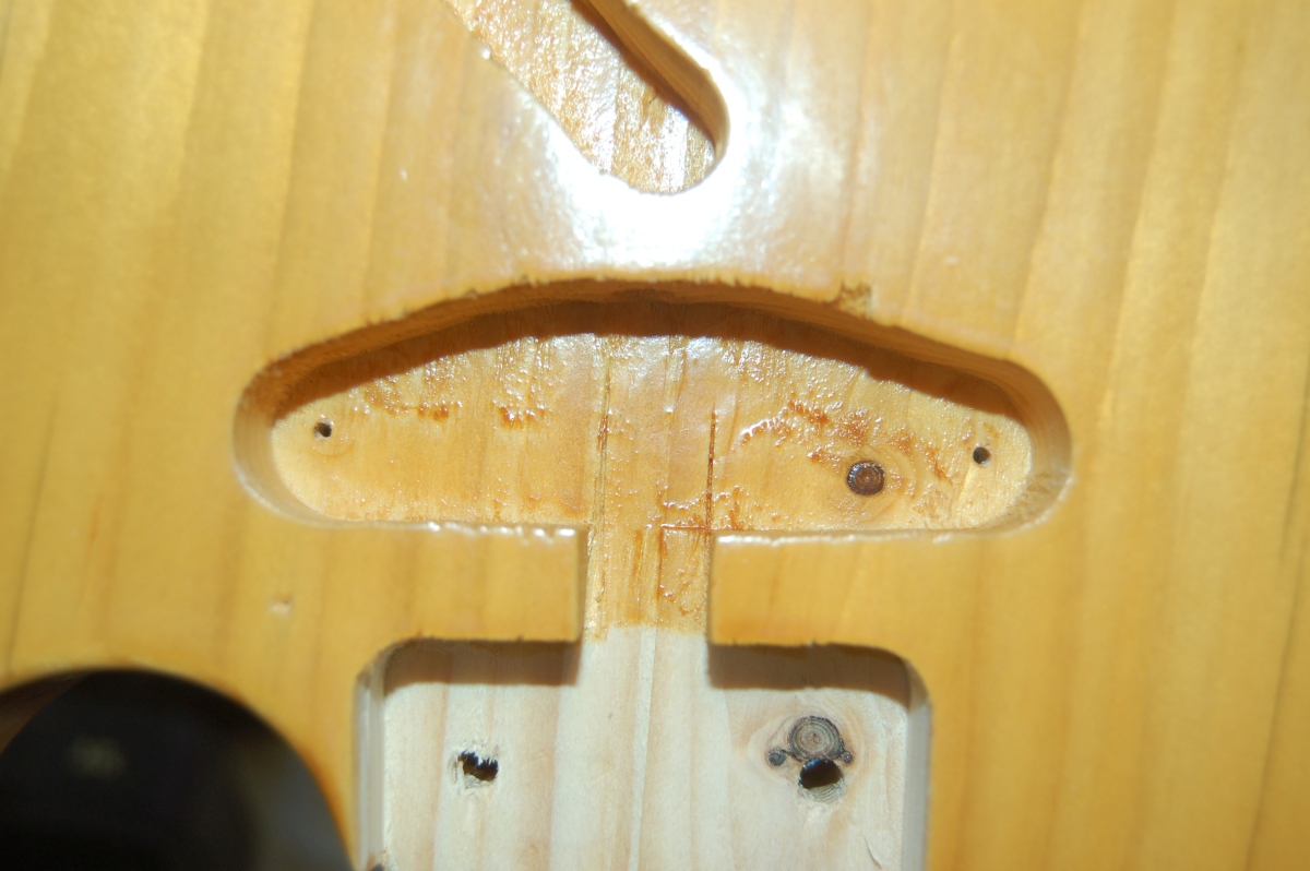 holes for neck pickup mounting screws drilled